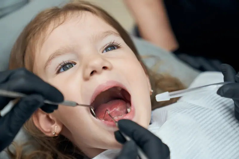 Child smiling during a visit to the dentist